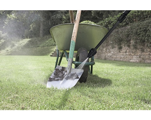 Un cărucior cu o lopată este curățat cu un curățător de înaltă presiune.