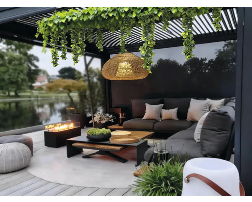 Terasa cu mobilier de lounge, vatră, lampă suspendată și plante sub o pergolă
