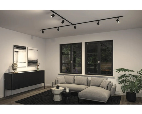 Cameră de zi cu sistem modern de șine de tavan cu spoturi, canapea și comodă