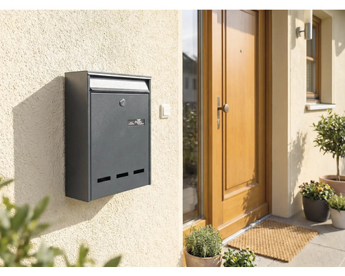 Cutie poștală antracit pe un perete al casei lângă o ușă de intrare