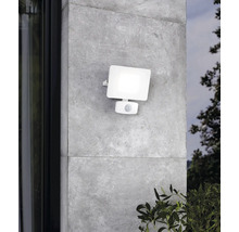 Lumină albă de exterior cu senzor de mișcare pe un perete gri