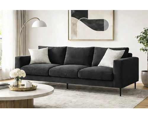 Living modern cu canapea gri închis cu trei locuri, picioare negre, măsuță rotundă din marmură, lampă aurie și tablou abstract.