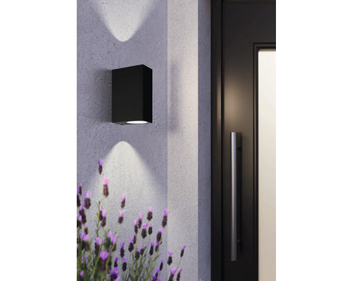 Lumină de perete cubică neagră lângă o ușă și lavandă