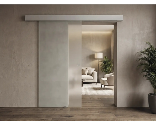 Ușă culisantă modernă din sticlă cu șină superioară și mâner rotund într-o cameră de zi luminoasă și minimalistă.