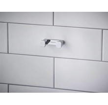 Cârlig dublu Hansgrohe din metal cromat pentru baie, montat pe un perete placat cu faianță.