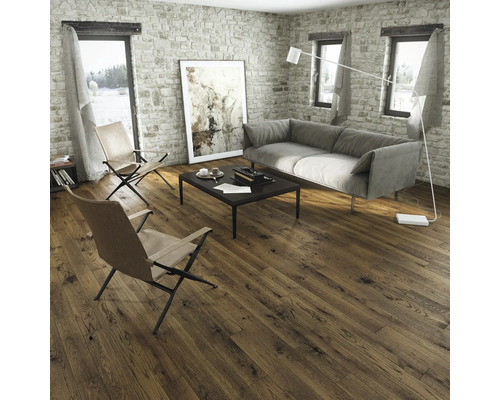 Sufragerie modernă cu pardoseală din lemn închis la culoare, canapea gri și pereți din piatră rustică. Design interior luminos și spațios.