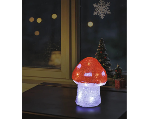Ciupercă decorativă LED iluminată din acril pe o masă, decorațiune de Crăciun la fereastră în fundal.