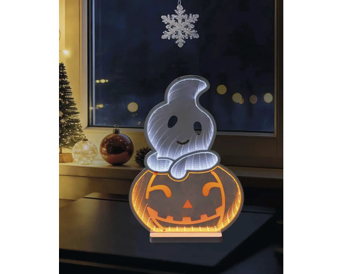 Decorațiune LED de Halloween cu un spirit pe un dovleac și efect de oglindă infinită, așezată pe o masă în fața unei ferestre cu decorațiuni de iarnă.