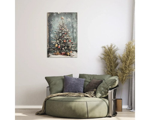 Tablou pe pânză cu brad de Crăciun împodobit într-o sufragerie modernă deasupra unui fotoliu rotund cu ierburi decorative.