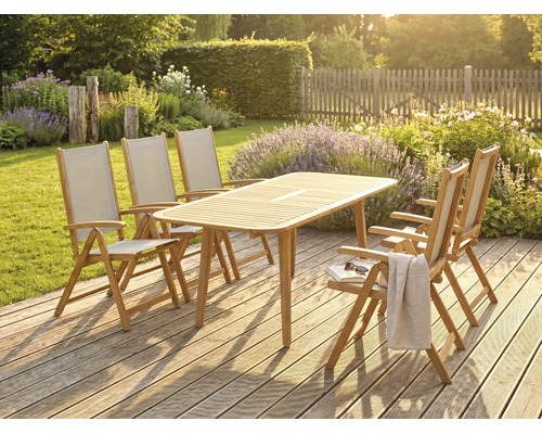Set de mobilier de grădină din lemn cu o masă dreptunghiulară și cinci scaune pliante pe o terasă din lemn într-o grădină însorită.