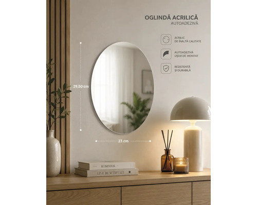 Oglindă acrilică autoadezivă ovală pe un perete deasupra unei comode, dimensiuni 29,50 centimetri pe 23 centimetri.