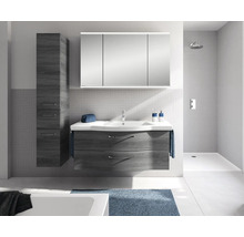 Set modern de mobilier de baie cu mască de chiuvetă închisă la culoare, lavoar alb, dulap cu oglindă cu trei uși și dulap înalt în baie luminoasă.