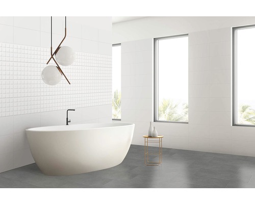 Baie modernă cu cadă independentă, faianță albă și gresie gri.