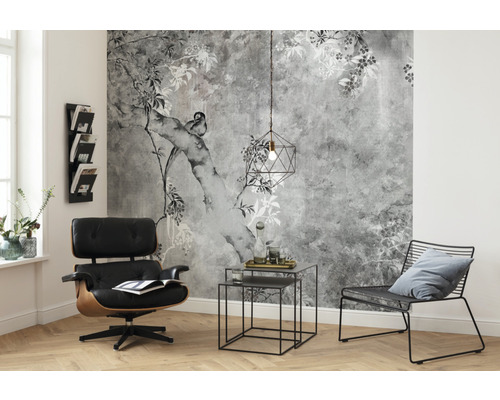 Cameră de zi cu tapet cu model, fotoliu, măsuță laterală și lampă