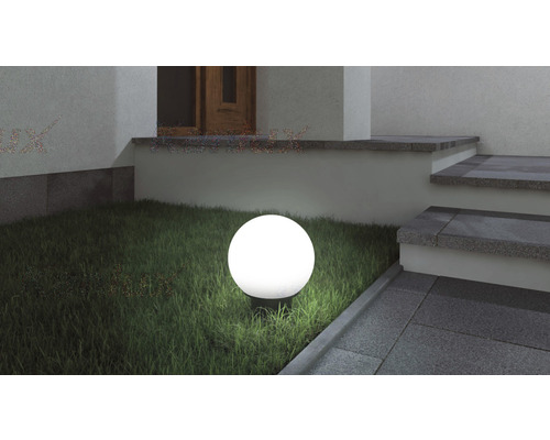 Spot luminos s formă sferică în exterior, lângă o scară