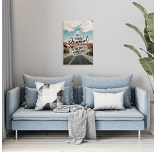 Tablou decorativ cu motiv stradal deasupra unei canapele într-un living.