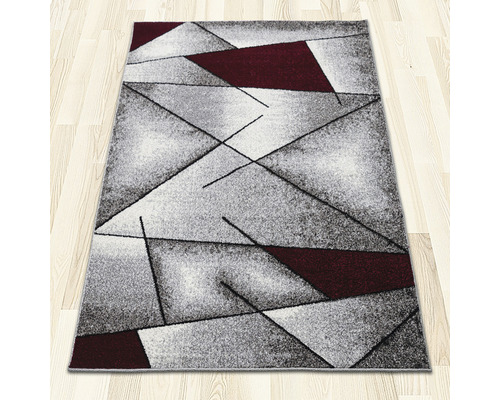 Covor cu model geometric pe podea din lemn deschis