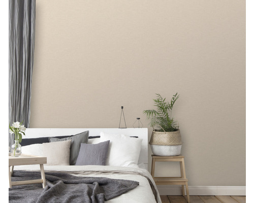 Dormitor cu tapet textil bej, pat și plantă de interior