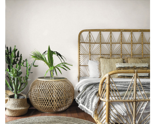 Dormitor în stil boem cu pat de bambus, măsuță laterală și plante de interior