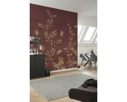 Living cu tapet cu model floral în maro roșcat, masă de sufragerie, scaune și covor gri.