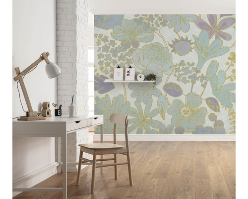 O cameră cu un birou, un scaun și un tapet floral.