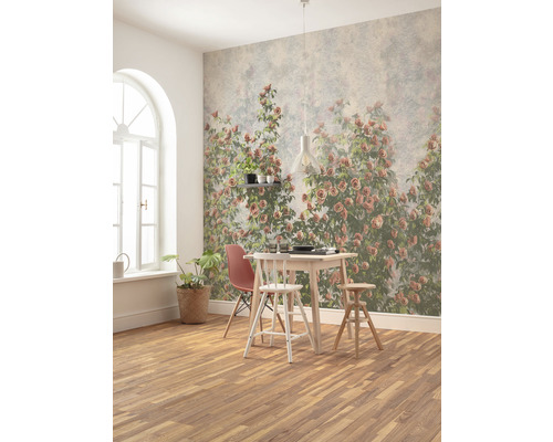 Sufragerie cu masă, scaune și tapet de perete cu motiv de trandafiri.