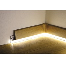 Colț cu plintă de lemn și iluminare indirectă