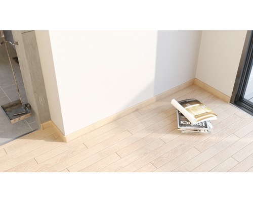 Pardoseală din lemn cu plintă și teanc de reviste