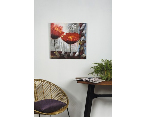 Pictură cu motiv floral pe perete deasupra unei mese și a unui scaun