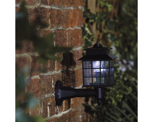 Lumină de perete neagră pe un zid de cărămidă.