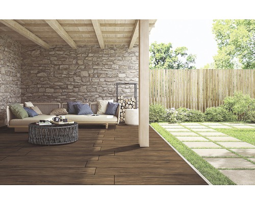 Terasa cu podea de lemn, perete de piatră și grădină