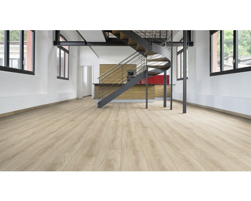 Podea laminată deschisă la culoare într-o cameră cu scară spirală și chicinetă