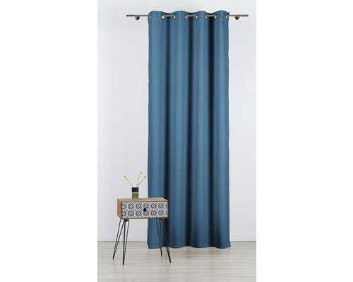 Cortină albastră cu suspensie cu ochiuri lângă o noptieră cu model