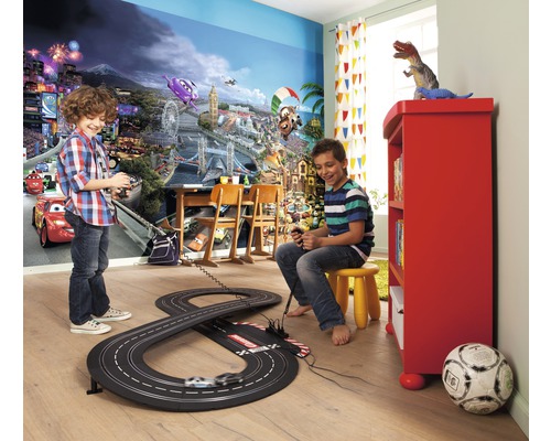 Cameră de copii cu fototapet, circuit de curse și doi băieți care se joacă