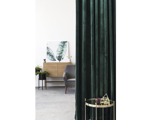 Interior cu perdele verzi, comodă, fotoliu și măsuță laterală