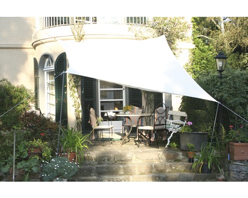 Grădină cu pânză de umbrire deasupra grupului de mese de terasă