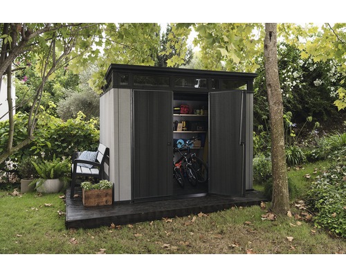 Magazie de grădină cu uși deschise și două biciclete în interior