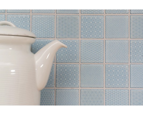 Plăci decorative de perete pătrate cu modele în spatele unui ceainic