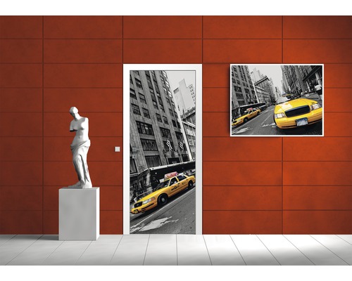 Interior decorativ cu poster de ușă și pictură murală cu motiv taxi și o sculptură.