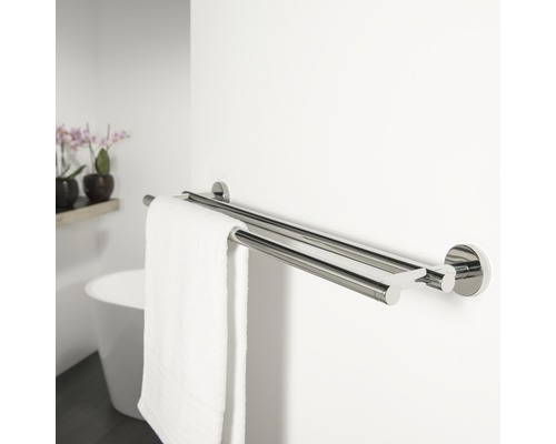 Suport dublu de prosoape metalic pe un perete de baie cu un prosop alb