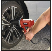 Un bărbat folosește o cheie de impact electrică Einhell pentru a monta o roată de mașină.