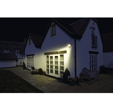 Casă iluminată cu reflector LED de exterior pe timp de noapte