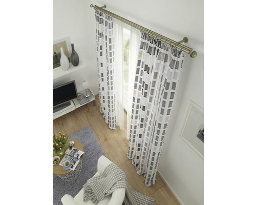 Cameră de zi cu fereastră, draperii și o cortină cu model geometric