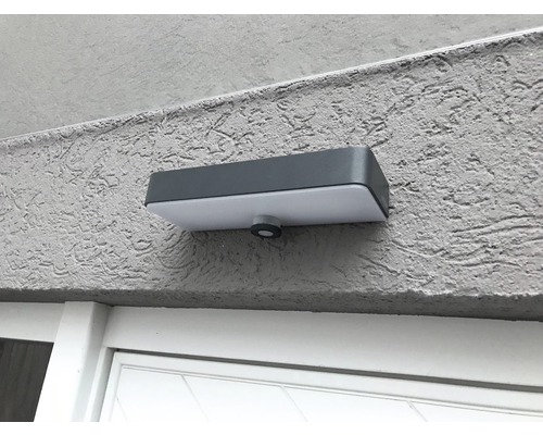 Lumină dreptunghiulară de exterior cu senzor de mișcare montată pe un perete