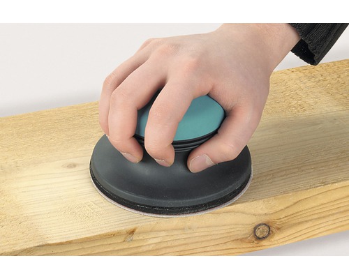 O șlefuitoare manuală este utilizată pe o scândură de lemn.