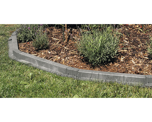 Peisaj de grădină cu gazon și un pat de flori înconjurat de o bordură de gazon din plastic.