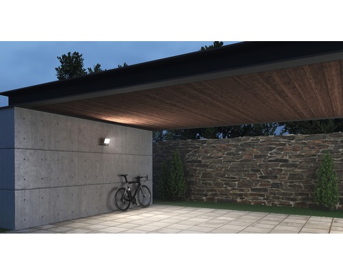 Garaj iluminat cu perete de beton, tavan cu grinzi de lemn și bicicletă