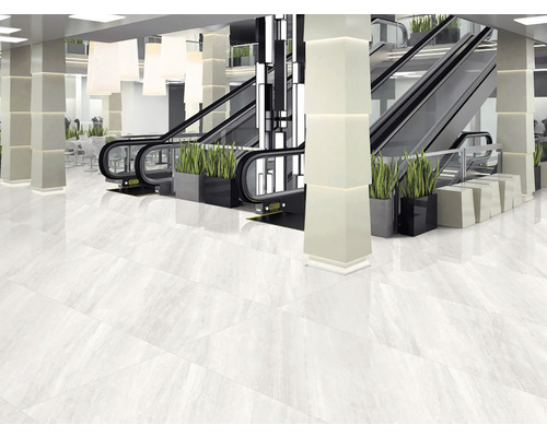 Interior luminos cu podea cu gresie lucioasă, scări rulante și coloane