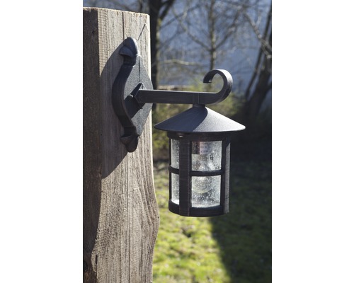 Lanternă de perete cu bec pe un stâlp de lemn