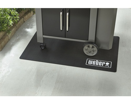 Covoraș pentru grătar Weber sub un grătar cu roți și dulap